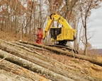 Komatsu working with logs